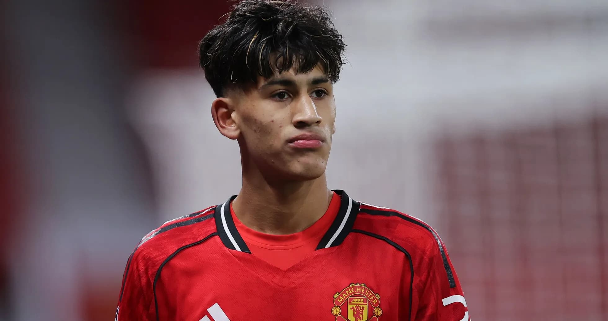 Young player in Manchester United kit on field