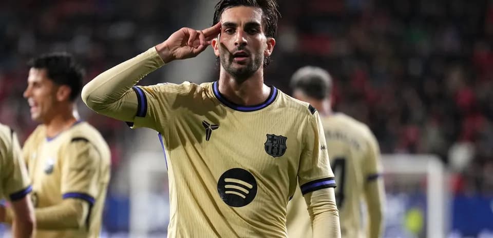Player celebrating with a salute gesture on pitch