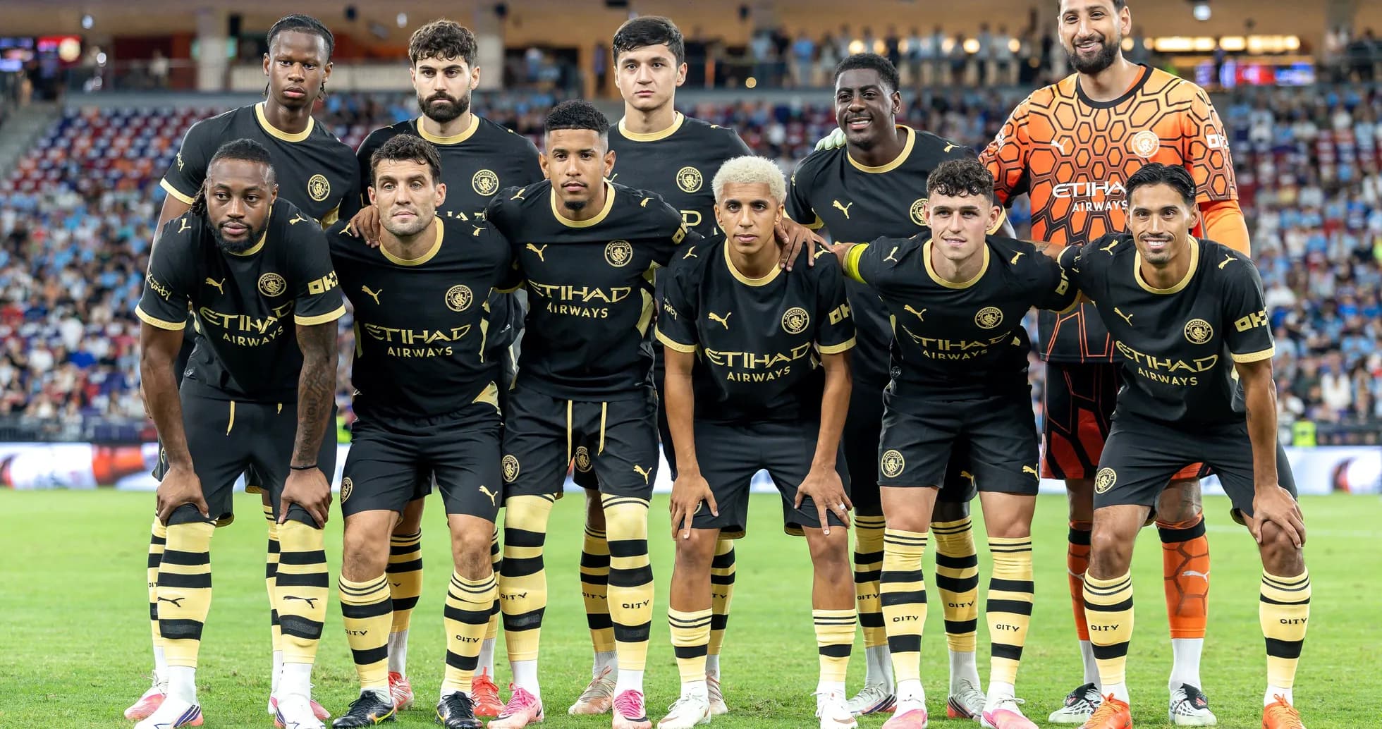 Football team posing for a group photo on field