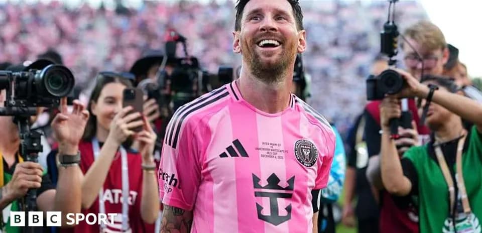 Player celebrating amidst photographers after match