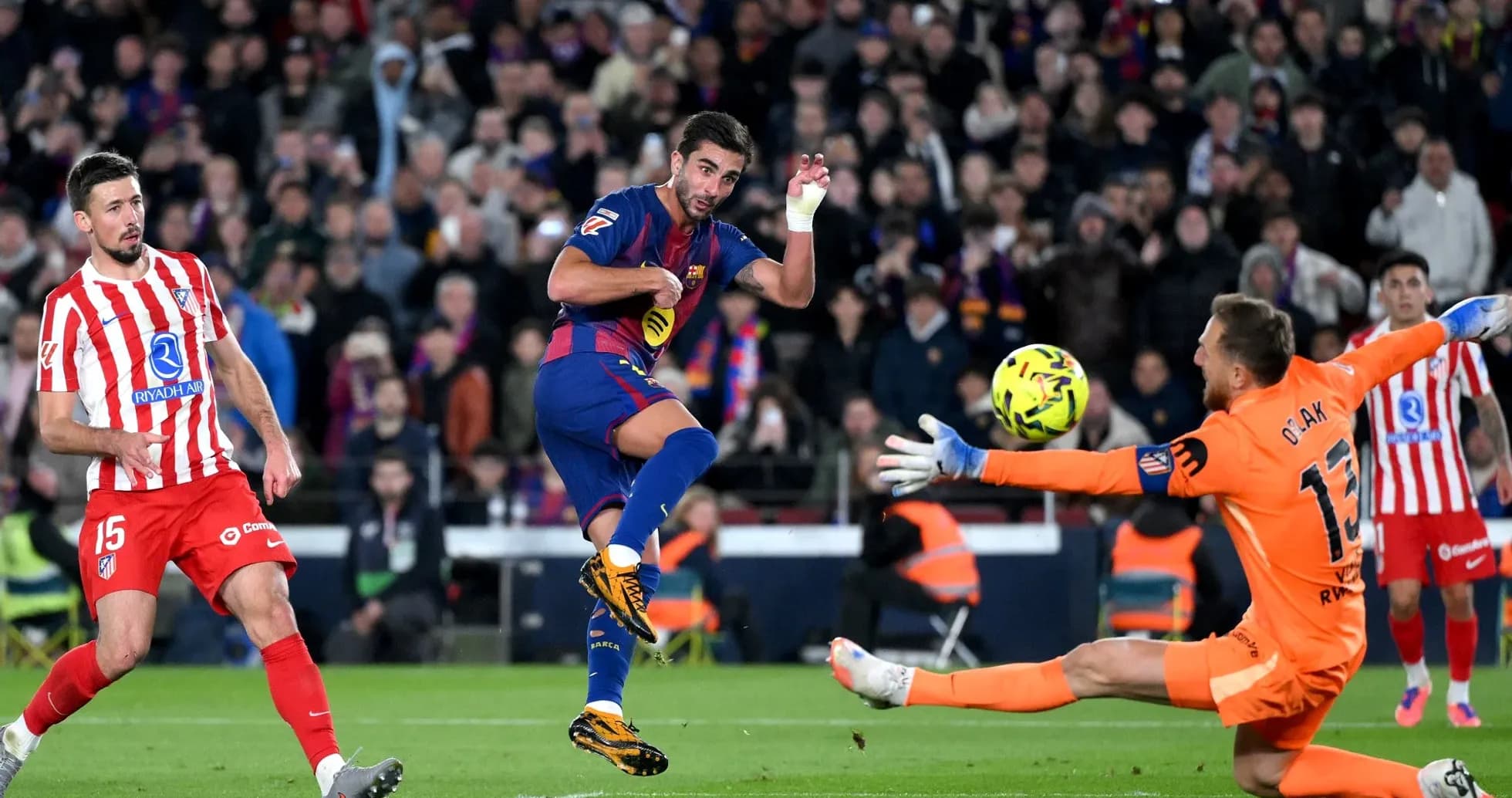 Barcelona player shooting against Atletico Madrid goalkeeper