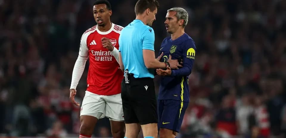 Players and referee discussing during match confrontation
