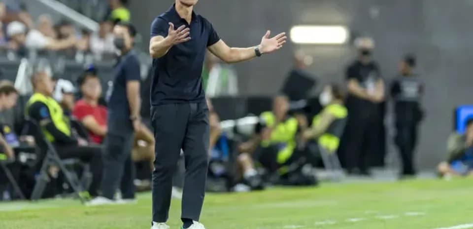 Coach gesturing from the sidelines during match