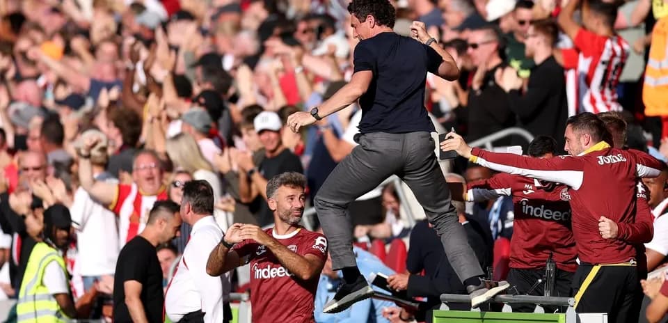 Manager celebrating with fans during match excitement