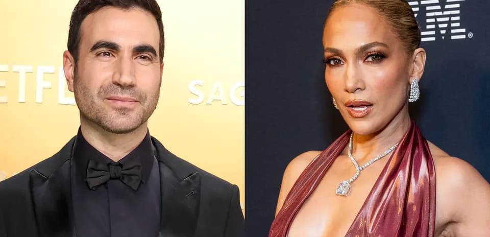 Two celebrities posing at red carpet event