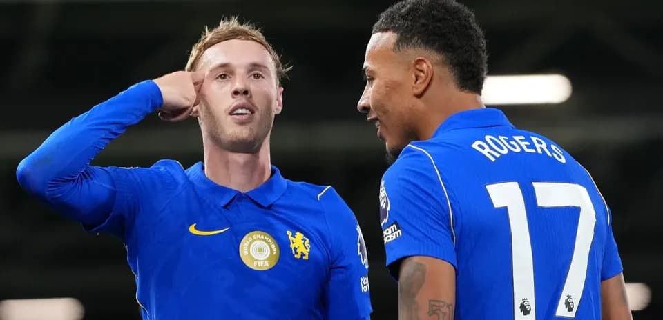 Two football players celebrating on the pitch