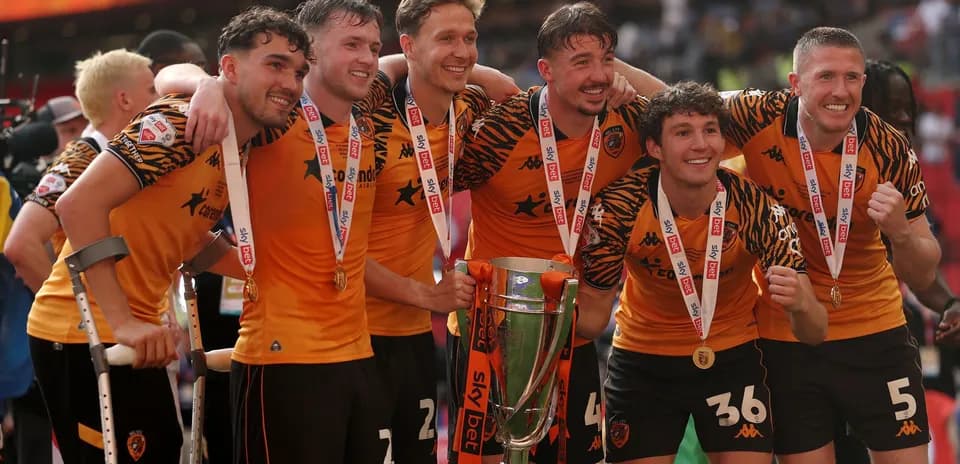 Team celebrating with trophy after championship victory