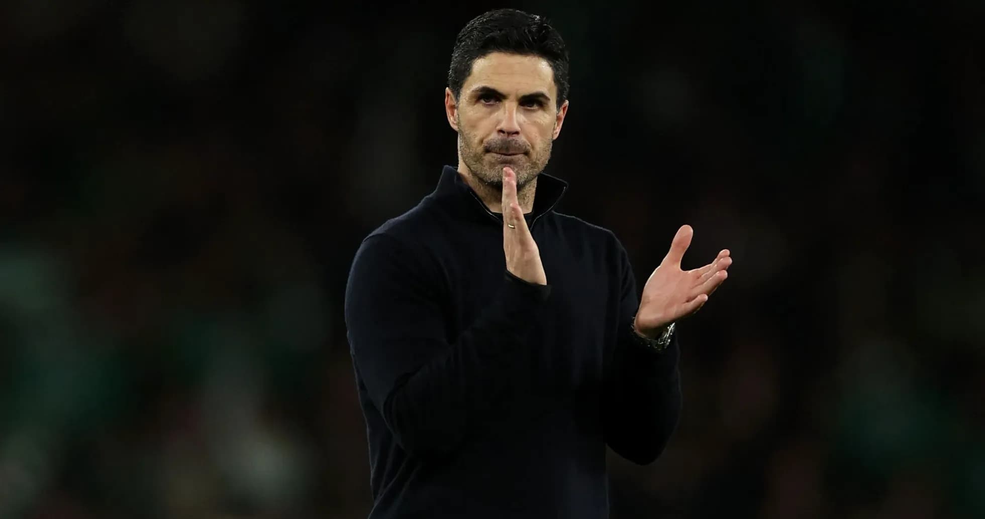 Manager applauding during a match on the sidelines