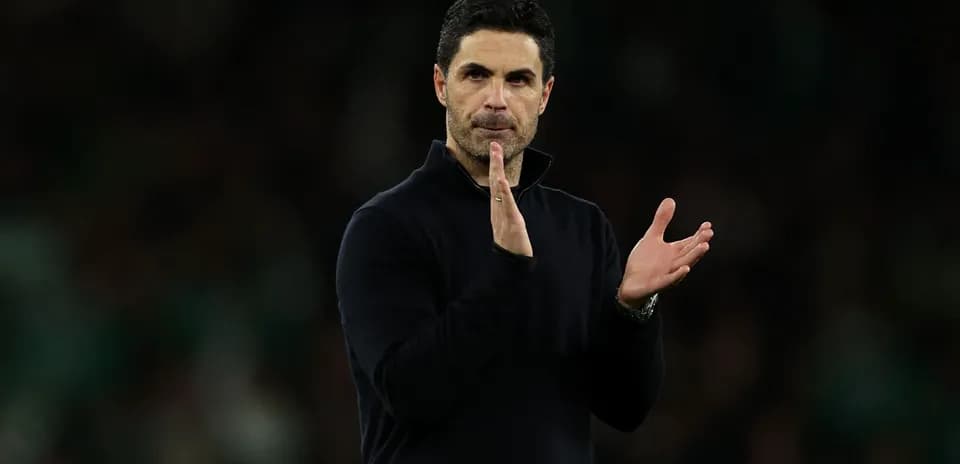 Manager applauding during a match on the sidelines