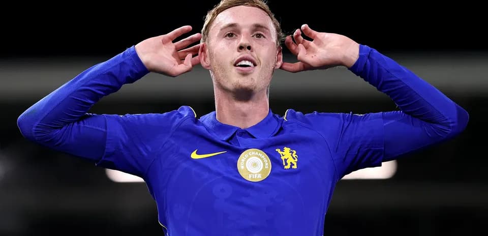 Player celebrating with hands to ears in blue jersey