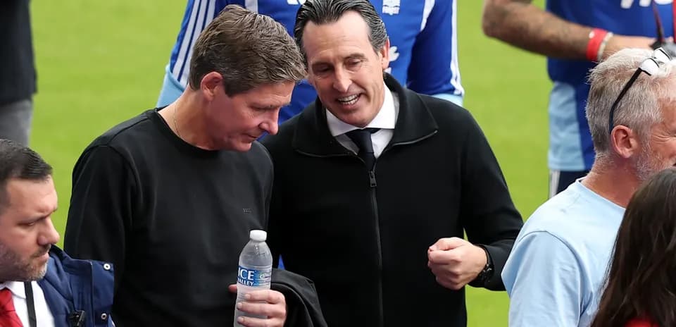 Two men talking on the pitch during match