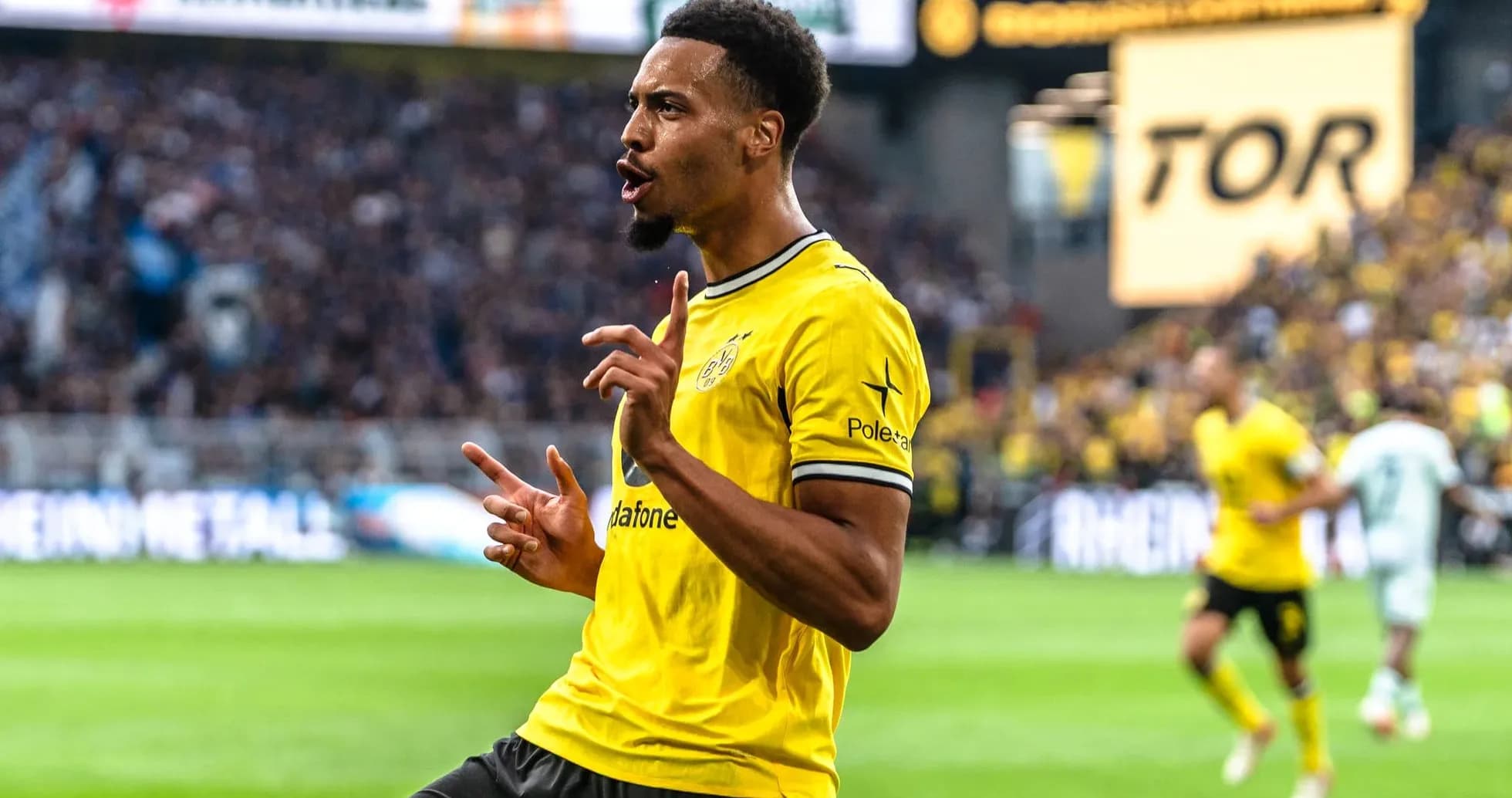Player celebrating a goal in yellow jersey