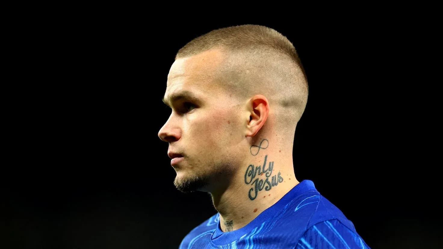 Player with tattoo wearing blue jersey in profile