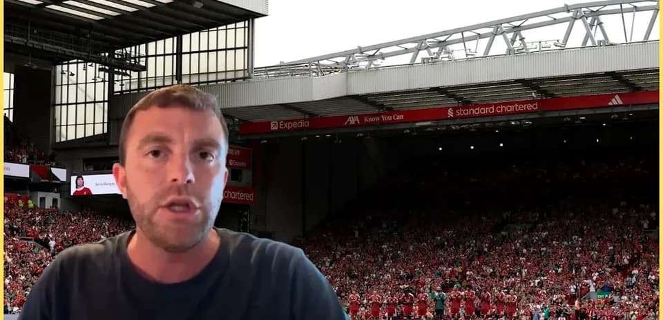 Speaker in front of Liverpool FC crowd at Anfield