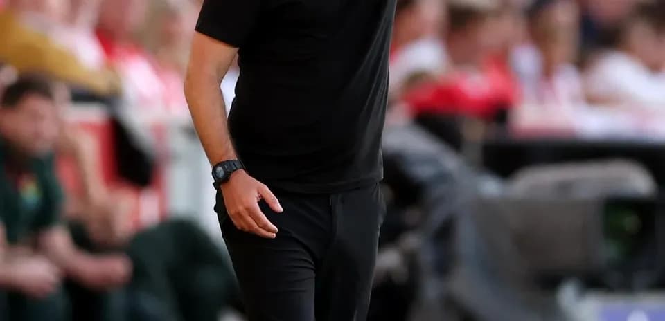 Coach giving instructions from the sideline during match