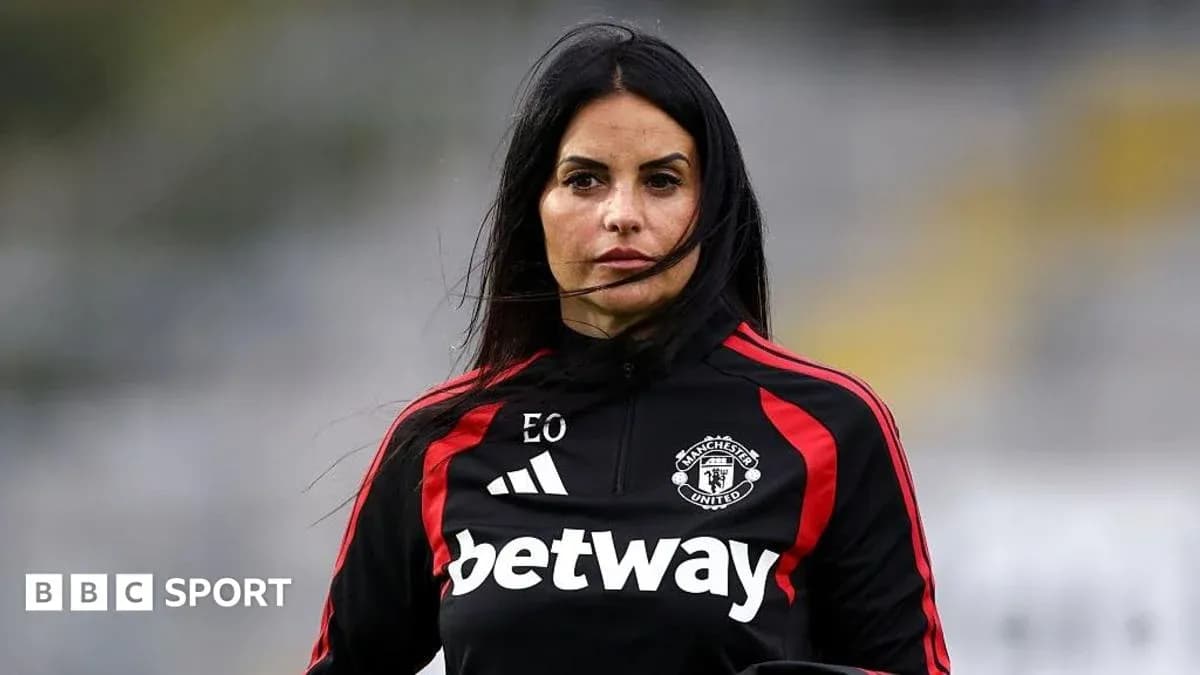 Woman in Manchester United training gear on pitch