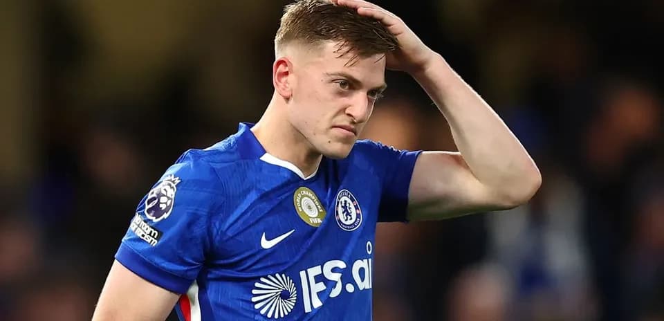 Player in blue jersey looking frustrated on pitch