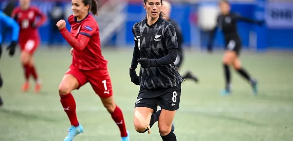 Player wearing black jersey running on the field