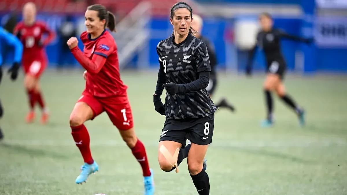 Player wearing black jersey running on the field