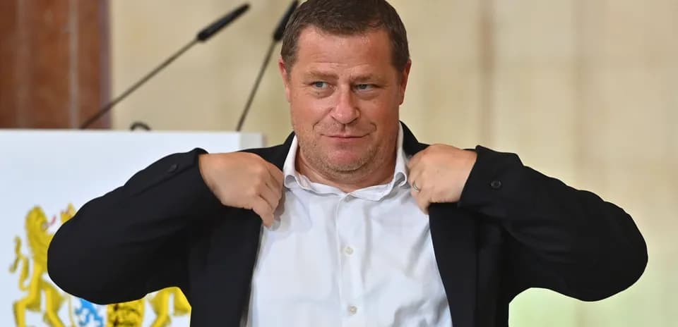 Man adjusting his jacket at podium