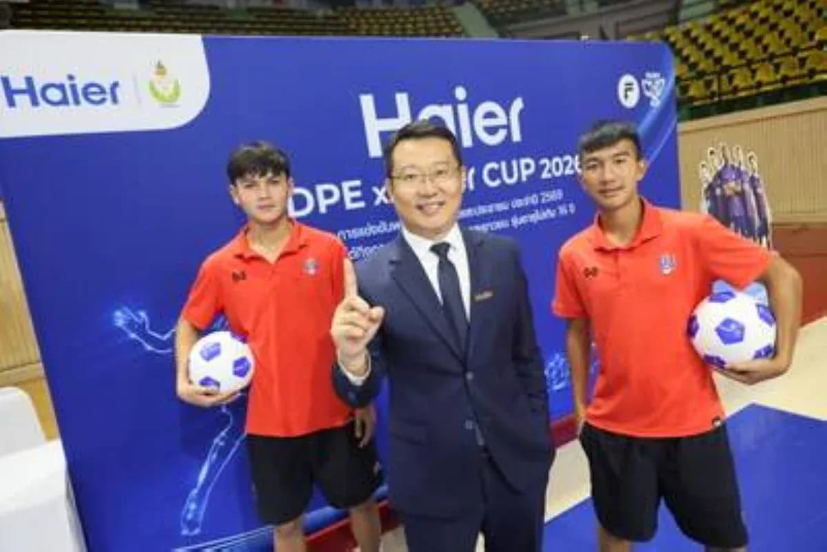 Two young players with a man in a suit