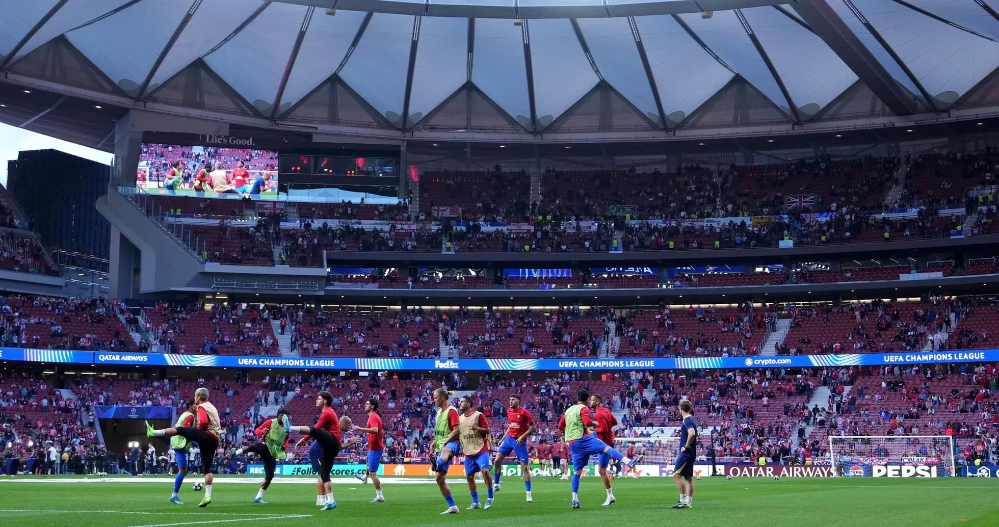 Players warming up on pitch before UEFA Champions League match