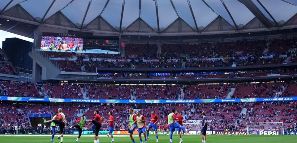Players warming up on pitch before UEFA Champions League match