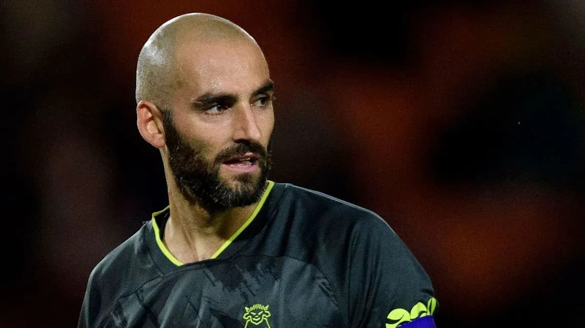 Goalkeeper wearing dark kit during match