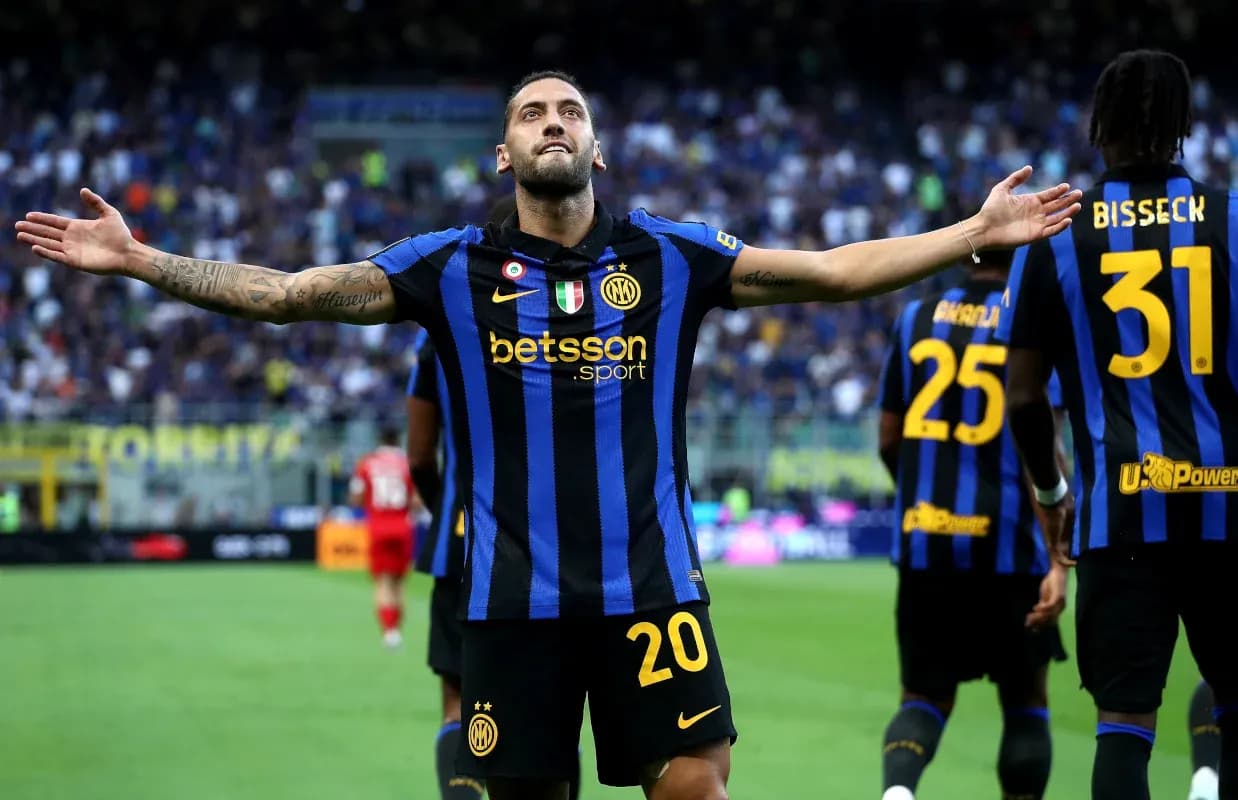 Player celebrating a goal with teammates in stadium