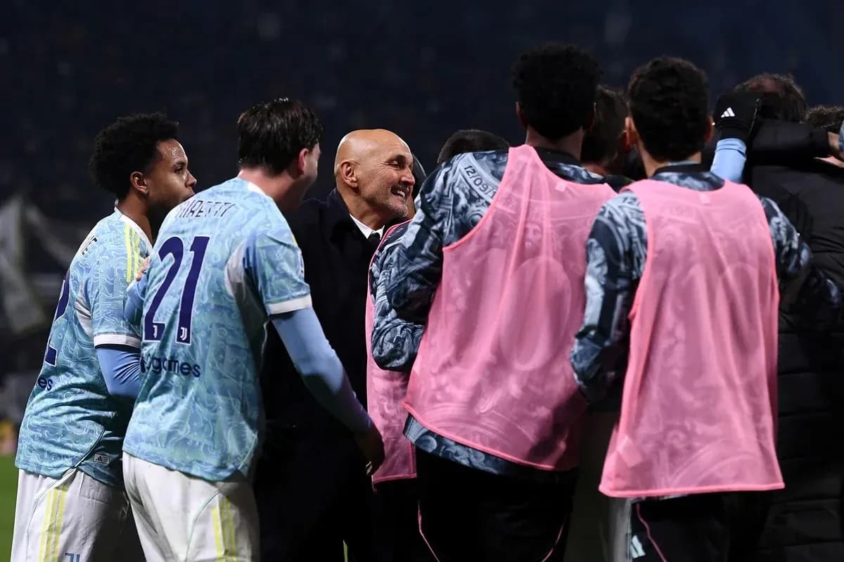 Players celebrating with coach after match victory