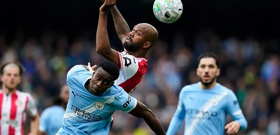 Manchester City player competing for the ball