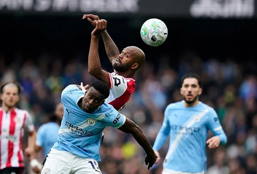Manchester City player competing for the ball