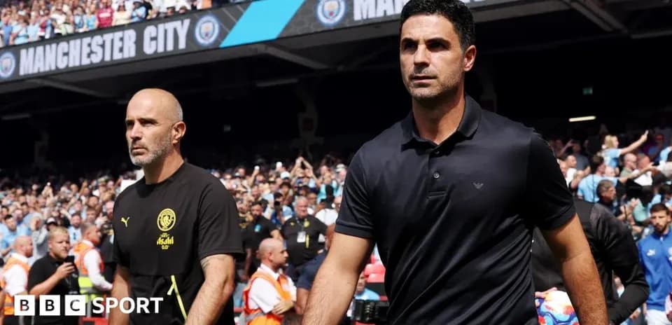 Coaches walking onto the pitch before the match