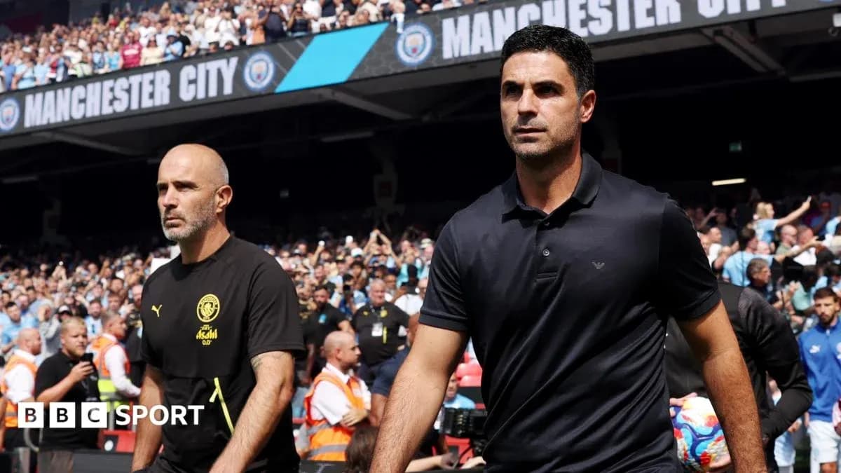 Coaches walking onto the pitch before the match