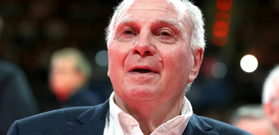 Older man in a suit at a sports event