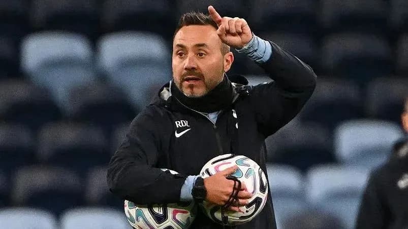 Coach directing players while holding soccer balls