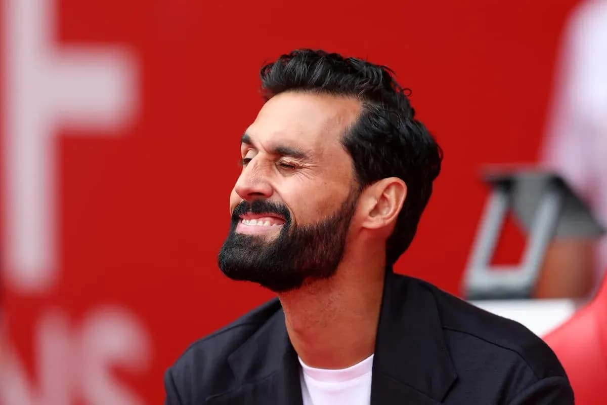 Man smiling while seated on the sidelines