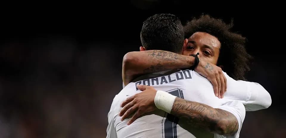 Cristiano Ronaldo and Marcelo embracing on field