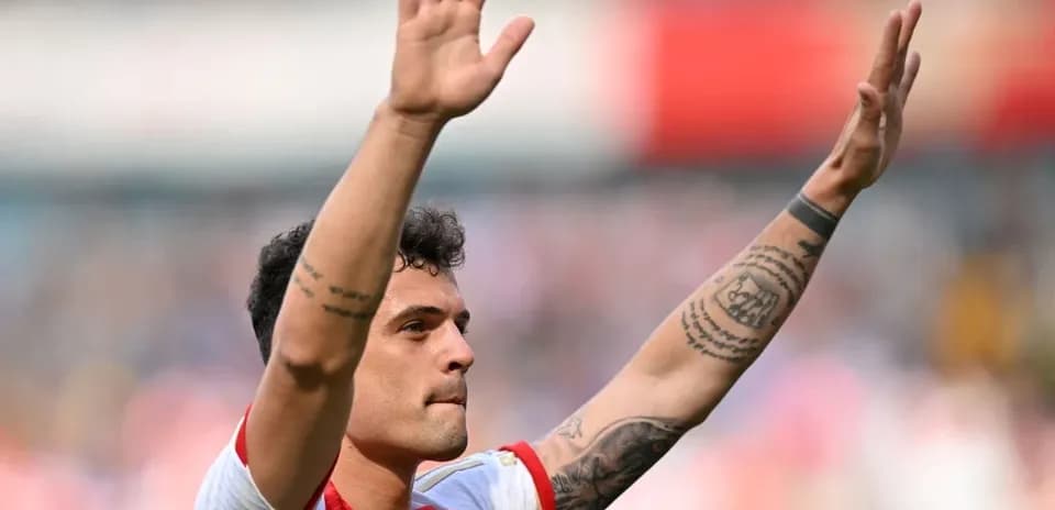 Player waving to fans after match at stadium