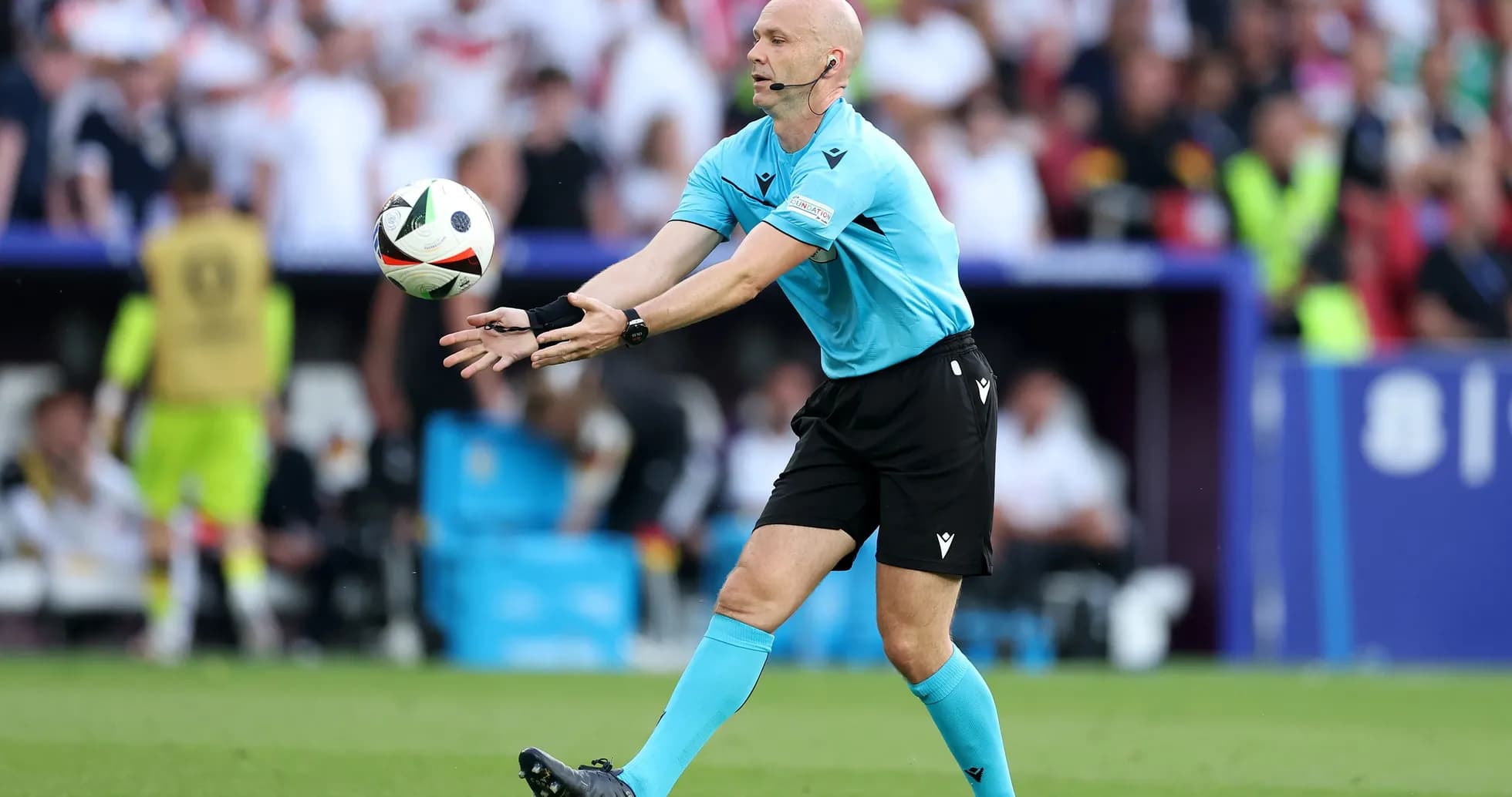 Referee throwing the ball during a football match