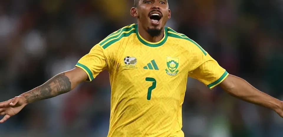 Player celebrating a goal in South Africa jersey