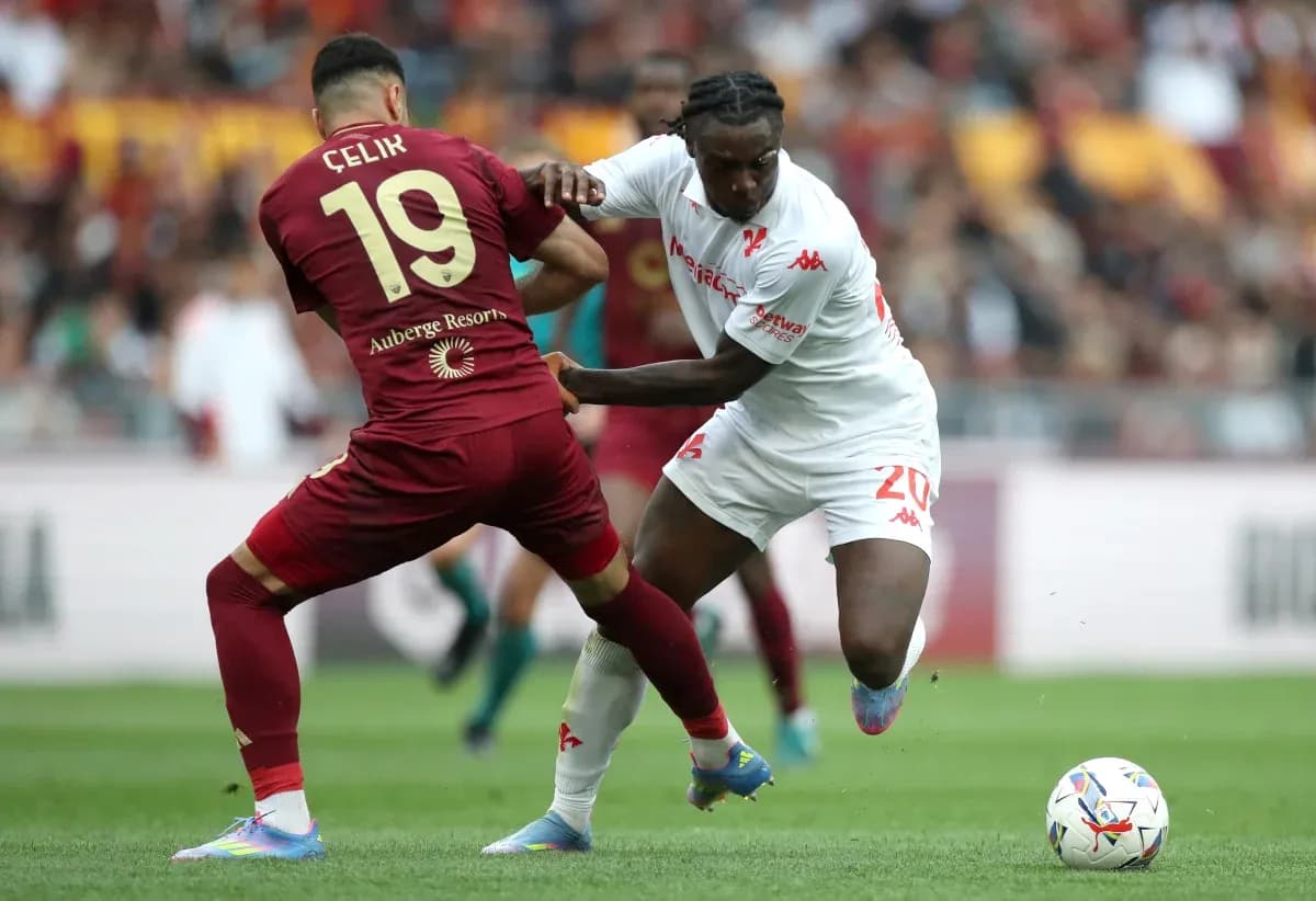 Celik and player battling for the ball