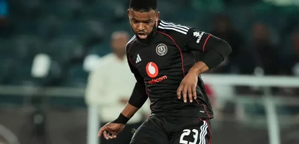 Player in black jersey dribbling the ball during match