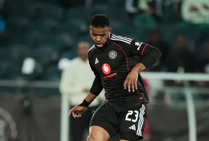 Player in black jersey dribbling the ball during match