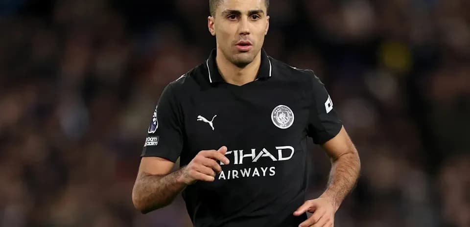 Player in black Manchester City kit running on field