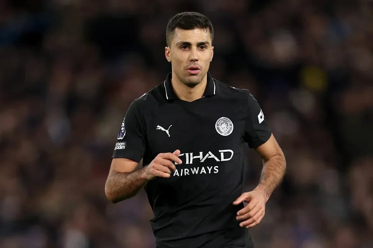 Player in black Manchester City kit running on field