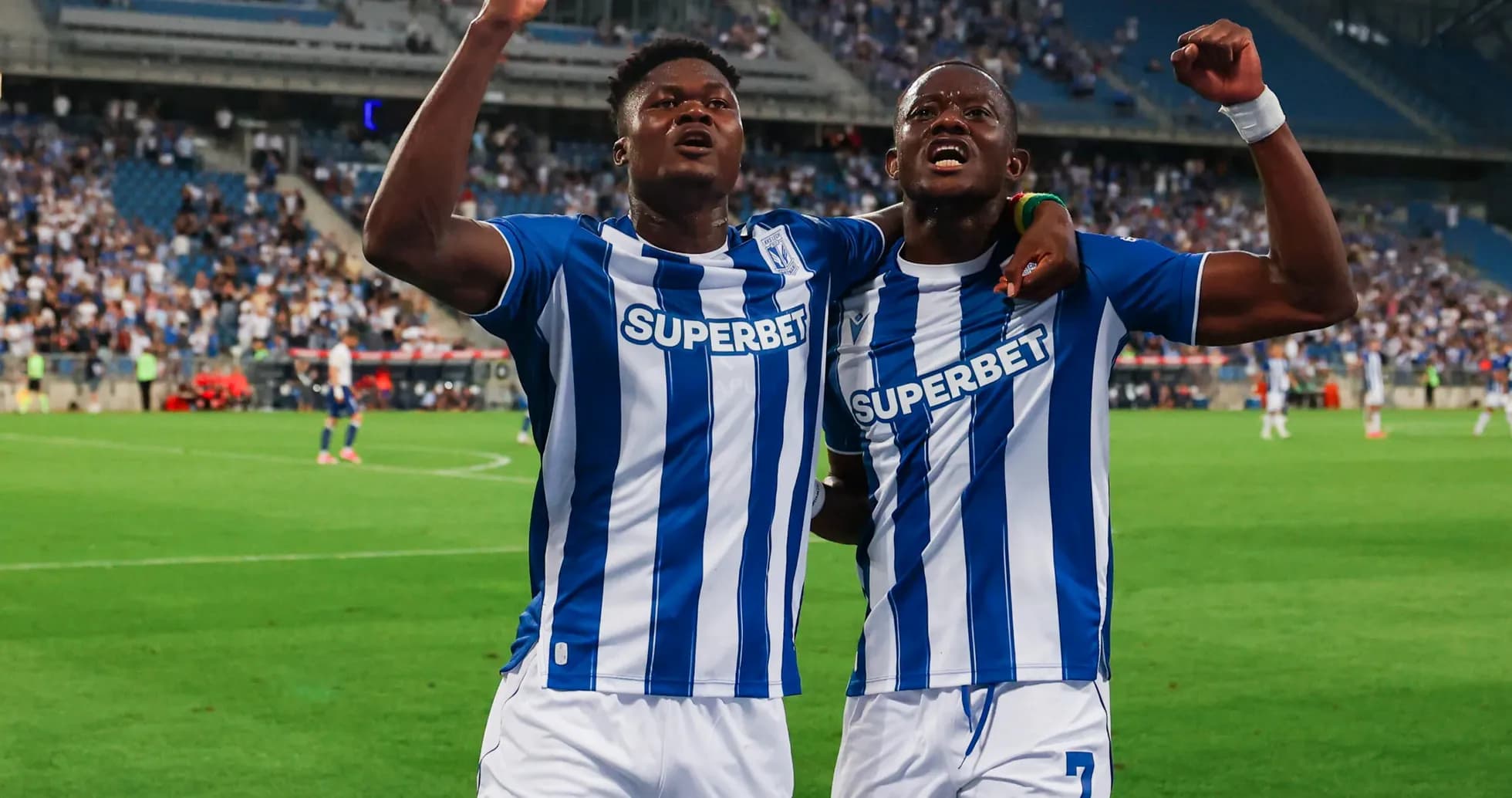 Two Lech Poznan players celebrating a goal