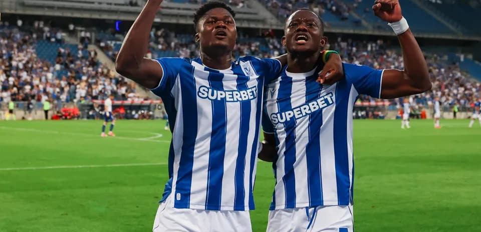 Two Lech Poznan players celebrating a goal