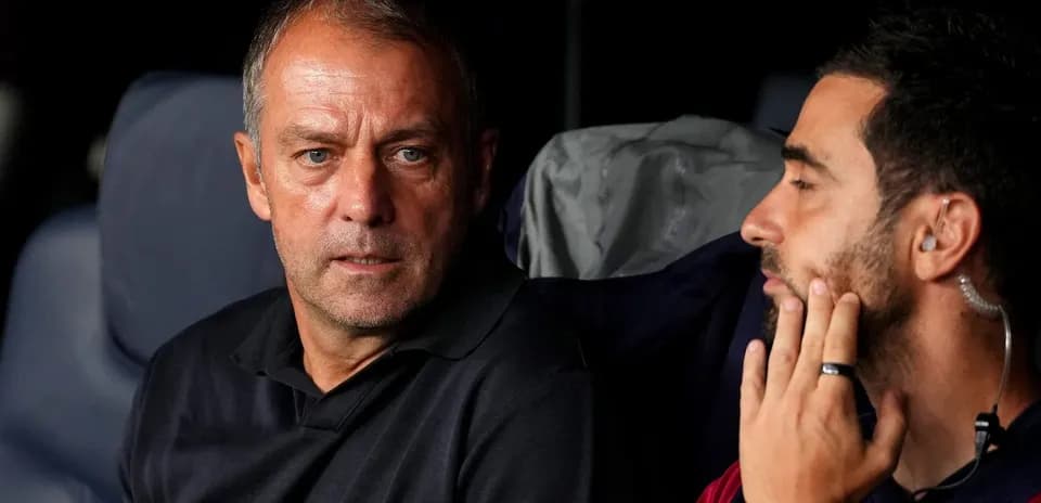 Two coaches discussing strategies on the bench