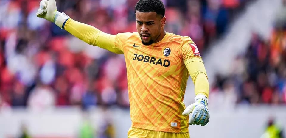 Goalkeeper signaling during a match in yellow uniform